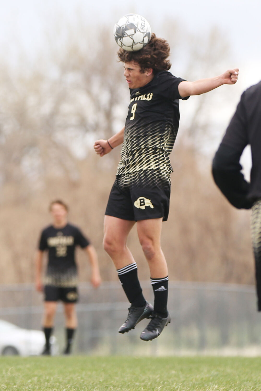 Anthony Peters jumps up to head a ball during the first half of the game